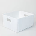 White ribbed wooden storage bin with cutout handles on a clean white background