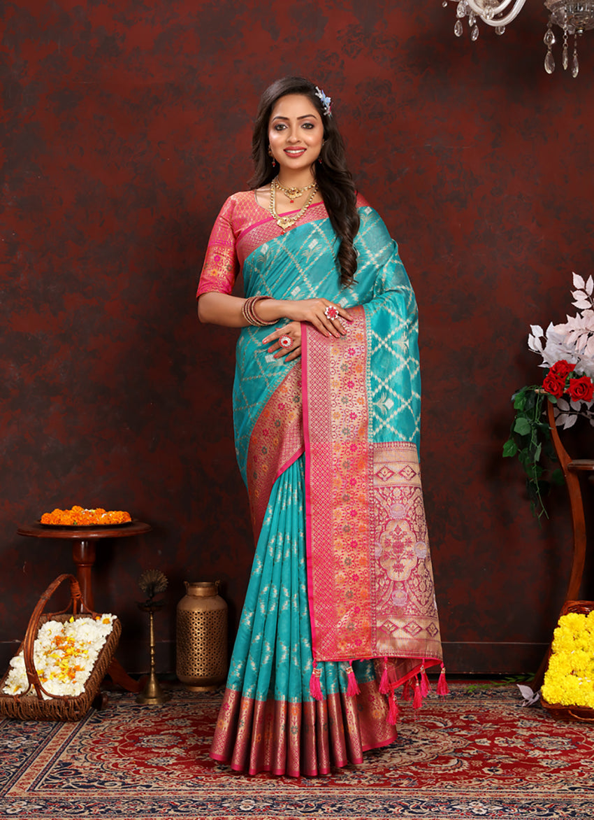 A beautiful Firozi Organza Silk saree with rich Meenakari woven pallu and matching silk blouse.
