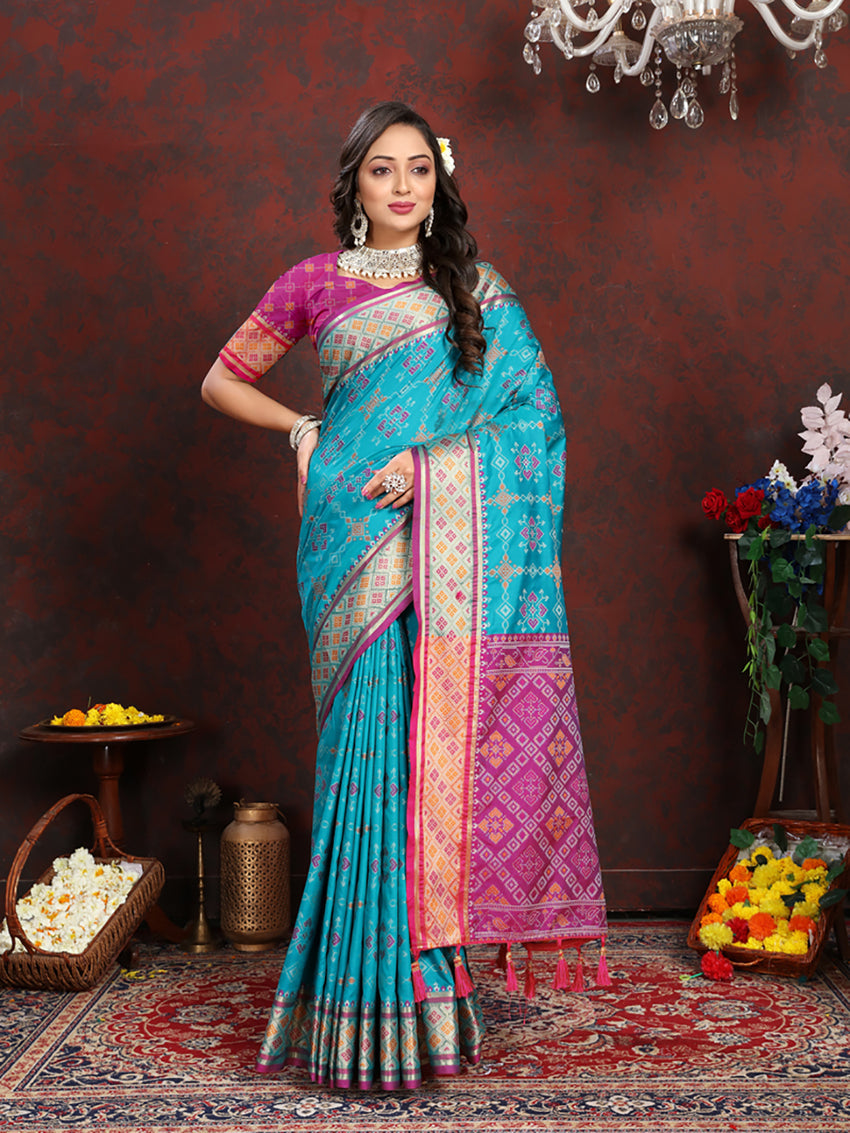 A vibrant Firozi Patola silk saree with detailed Zari Meenakari weaving on the pallu.