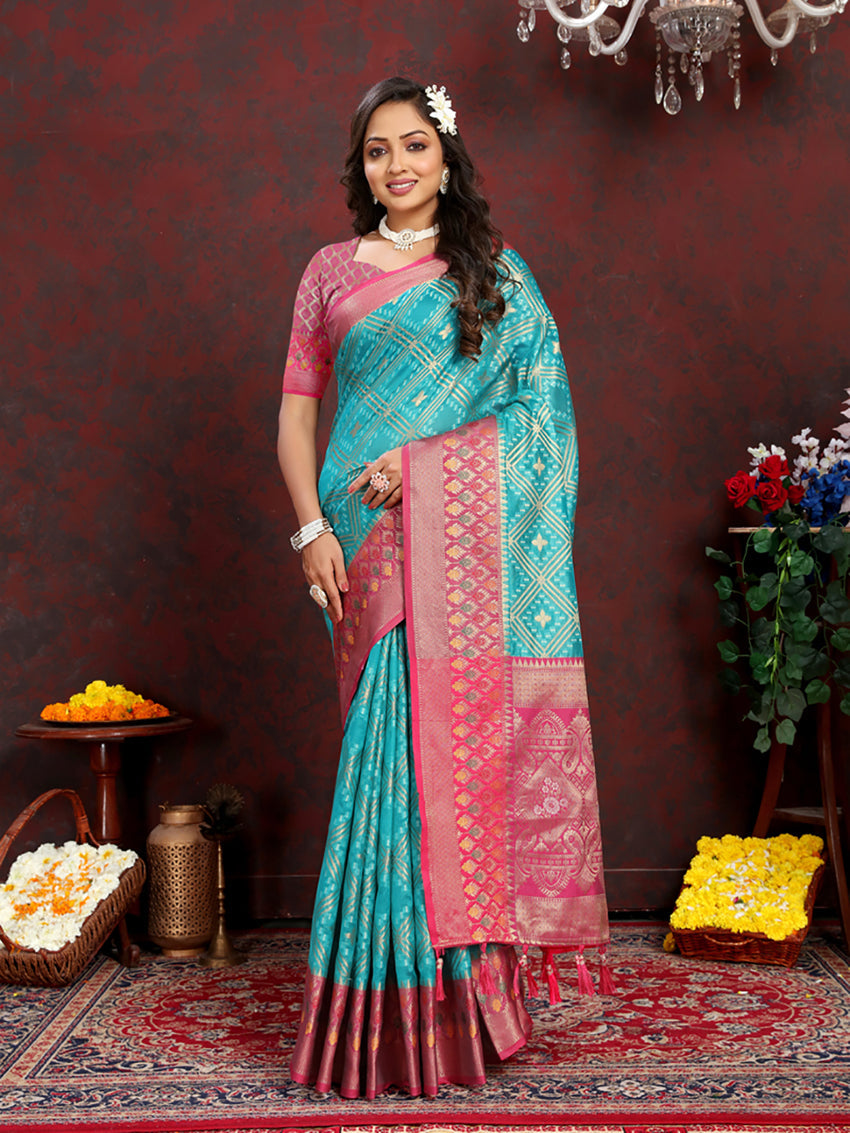 Firozi organza silk saree with geometric woven patterns and a rich Meenakari pallu in pink and gold