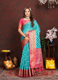 Dista Firozi Organza Silk saree with rich Meenakari woven pallu, zari border, and tassels.