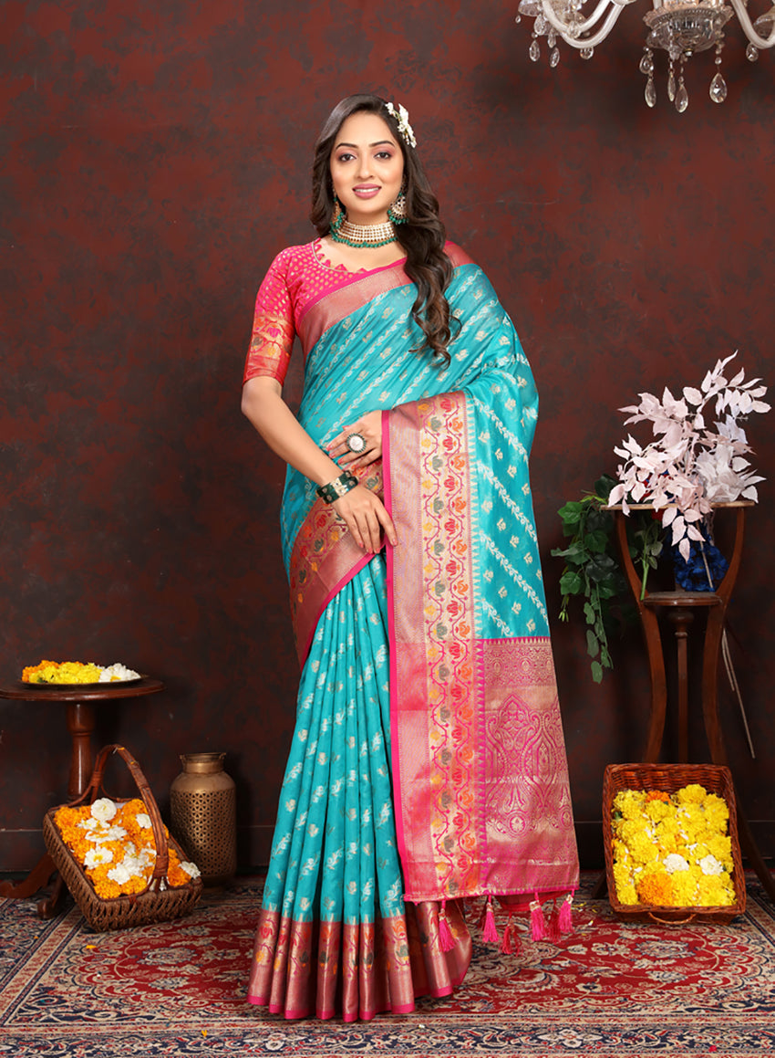 Dista Firozi Organza Silk saree with rich Meenakari woven pallu, zari border, and tassels.