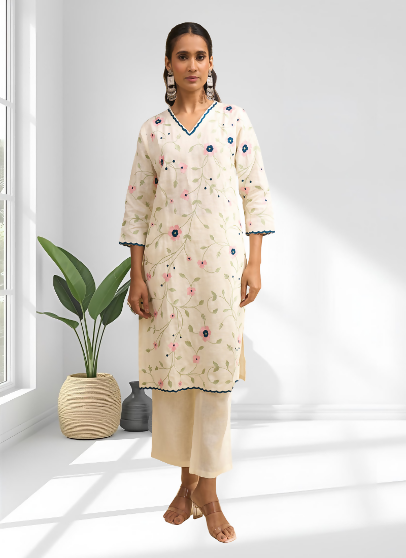 Cream linen long kurta with delicate embroidery paired with matching trousers