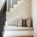 Oaklyn floral wallpaper with sage green, blue, and dusty-pink flowers on an off-white background