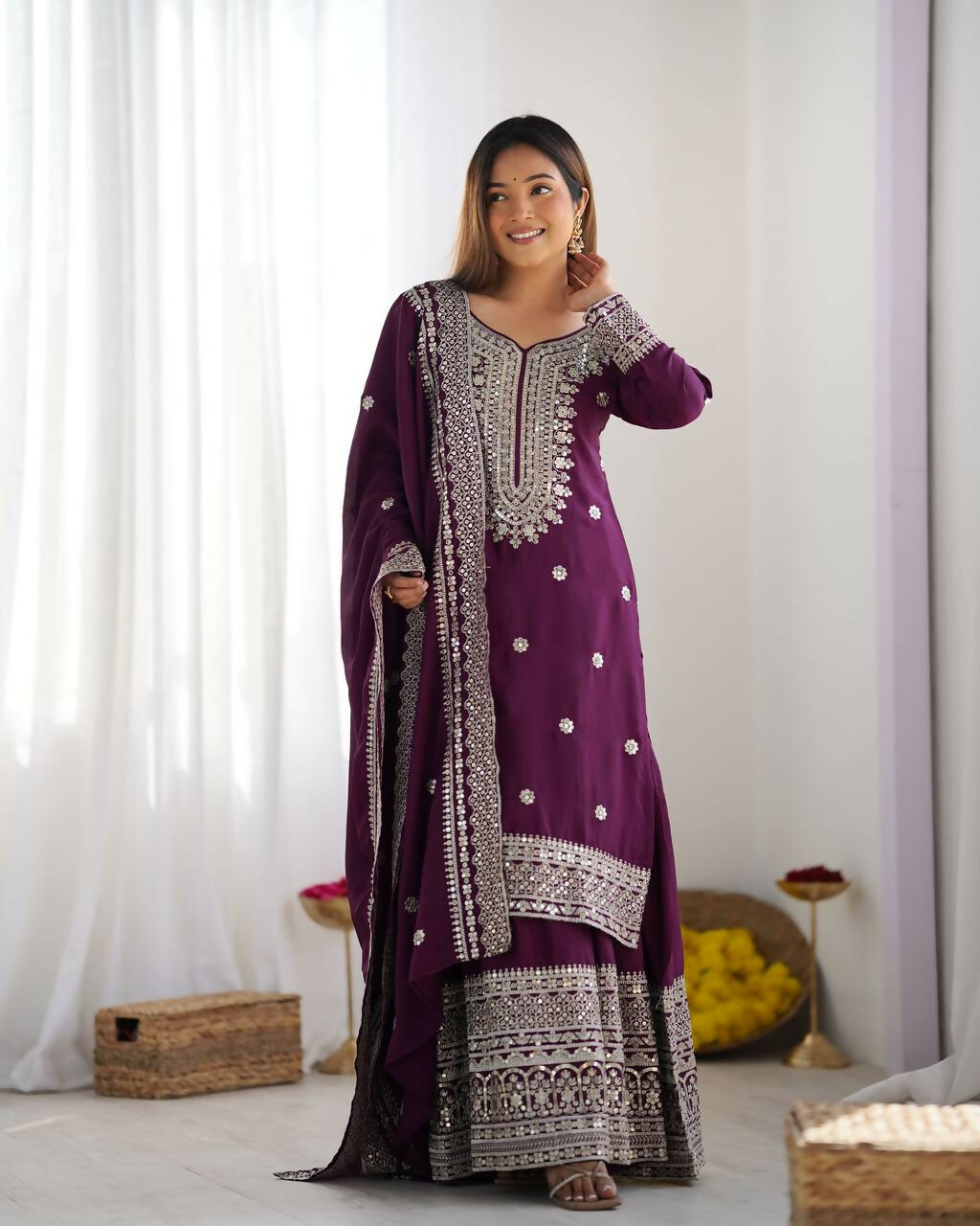 Wine-colored silk kurta set with detailed sequins and zari embroidery