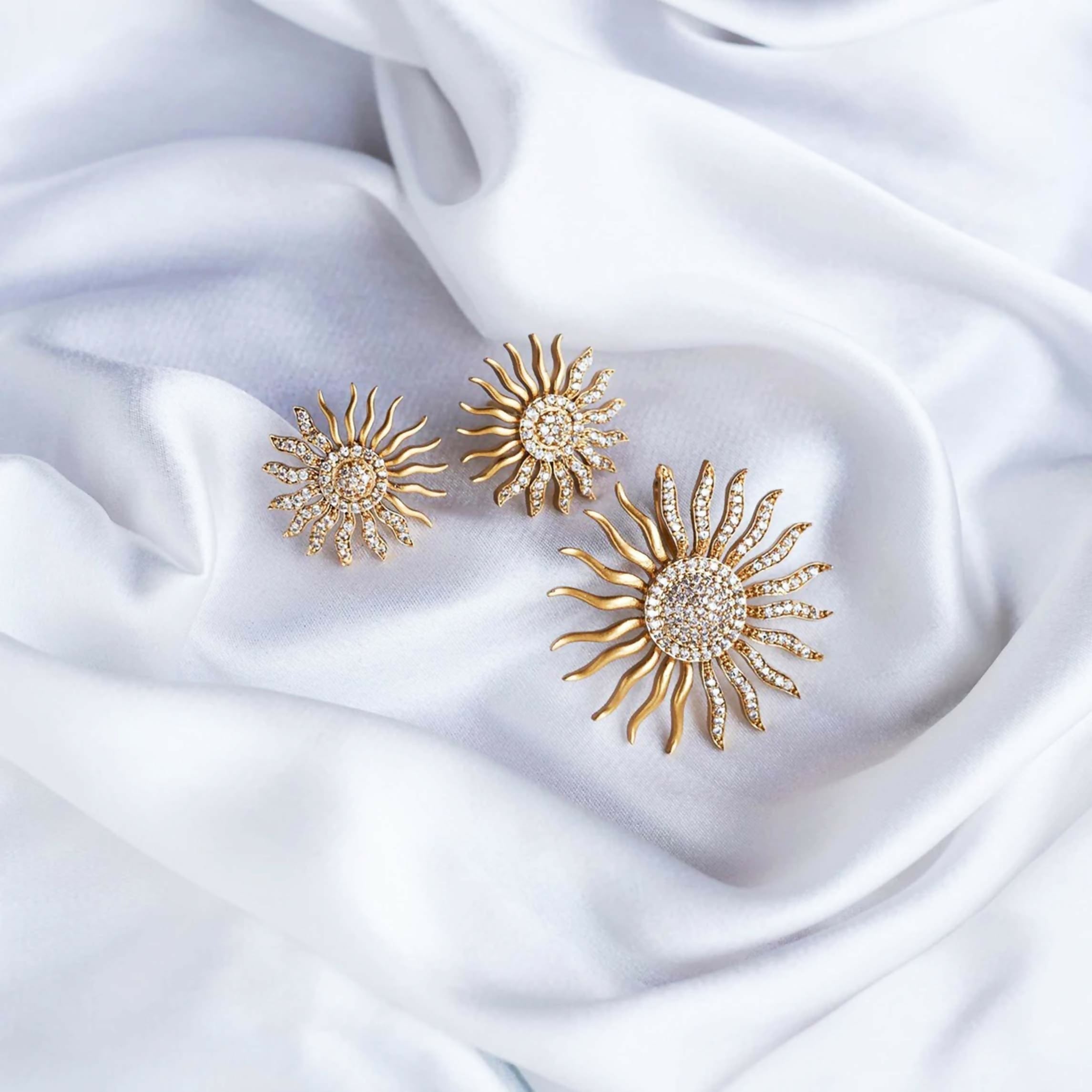 Close-up of a gold-tone brass locket with a shimmering white opal stone, elegant jewelry photography.