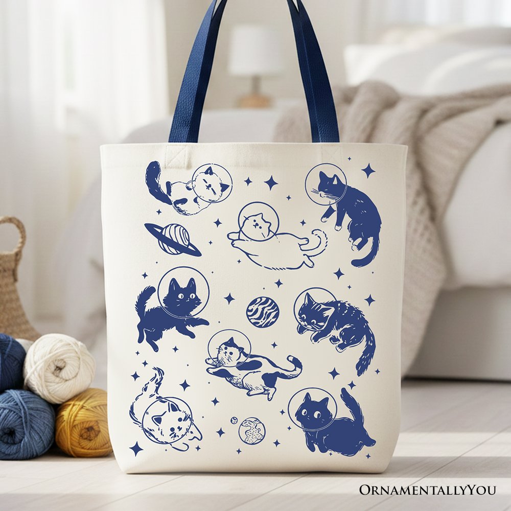 A retro-style canvas tote bag featuring a funny astronaut cat in space, printed on both sides.