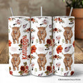 Personalized 20oz Highland Cow floral tumbler with stainless steel straw on a rustic wooden background