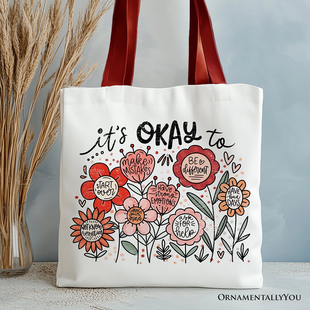It's Okay floral affirmation canvas tote bag with red, pink, and orange details.