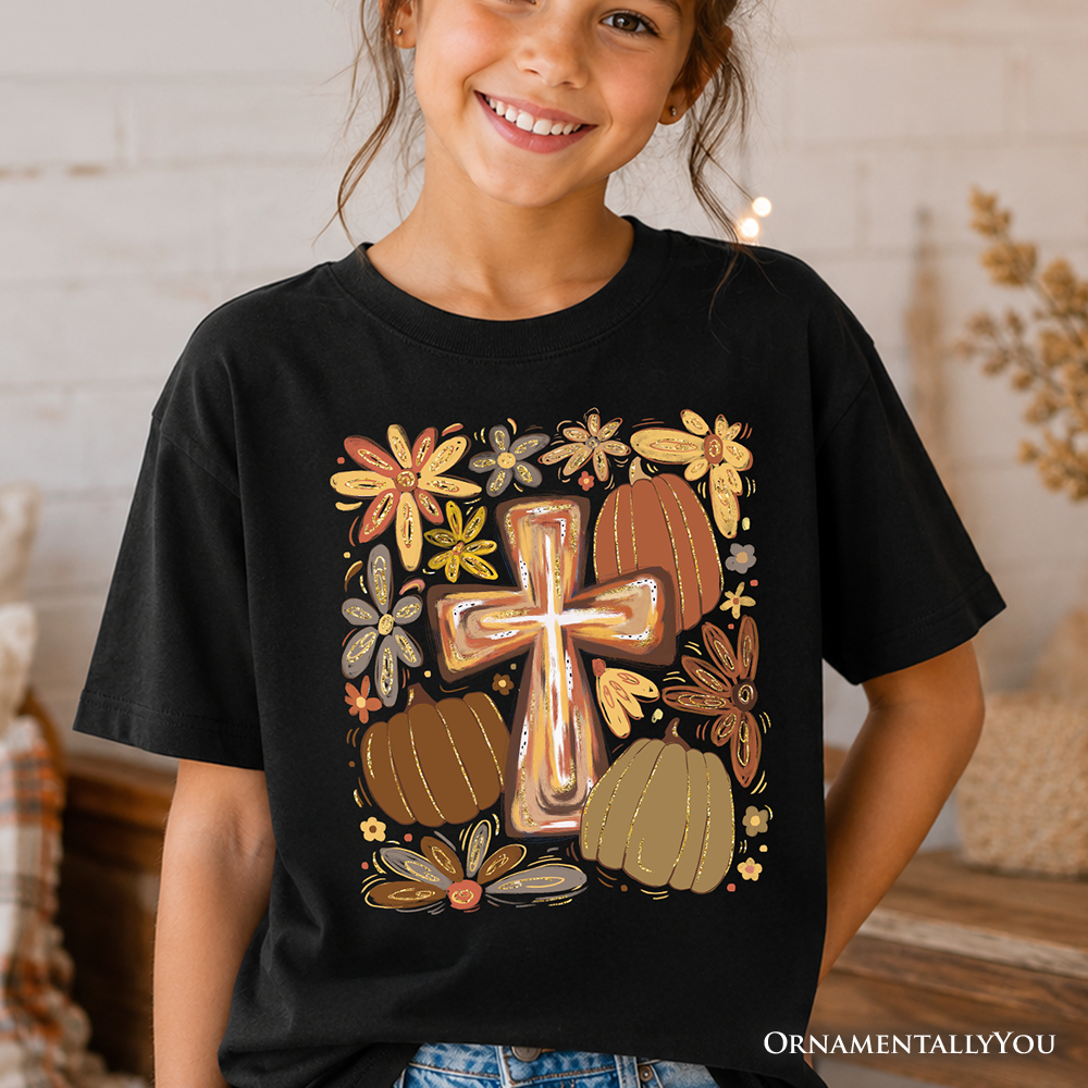 Child wearing a soft cotton fall blessings graphic T-shirt in an autumn-themed setting