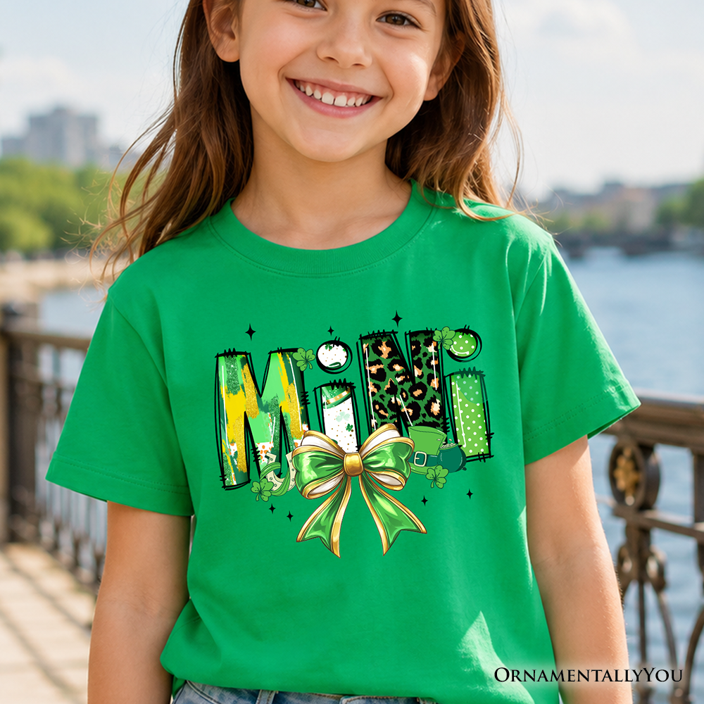 Child wearing a t-shirt featuring a cute clover shamrock graphic with a bow, perfect for St. Patrick's Day.
