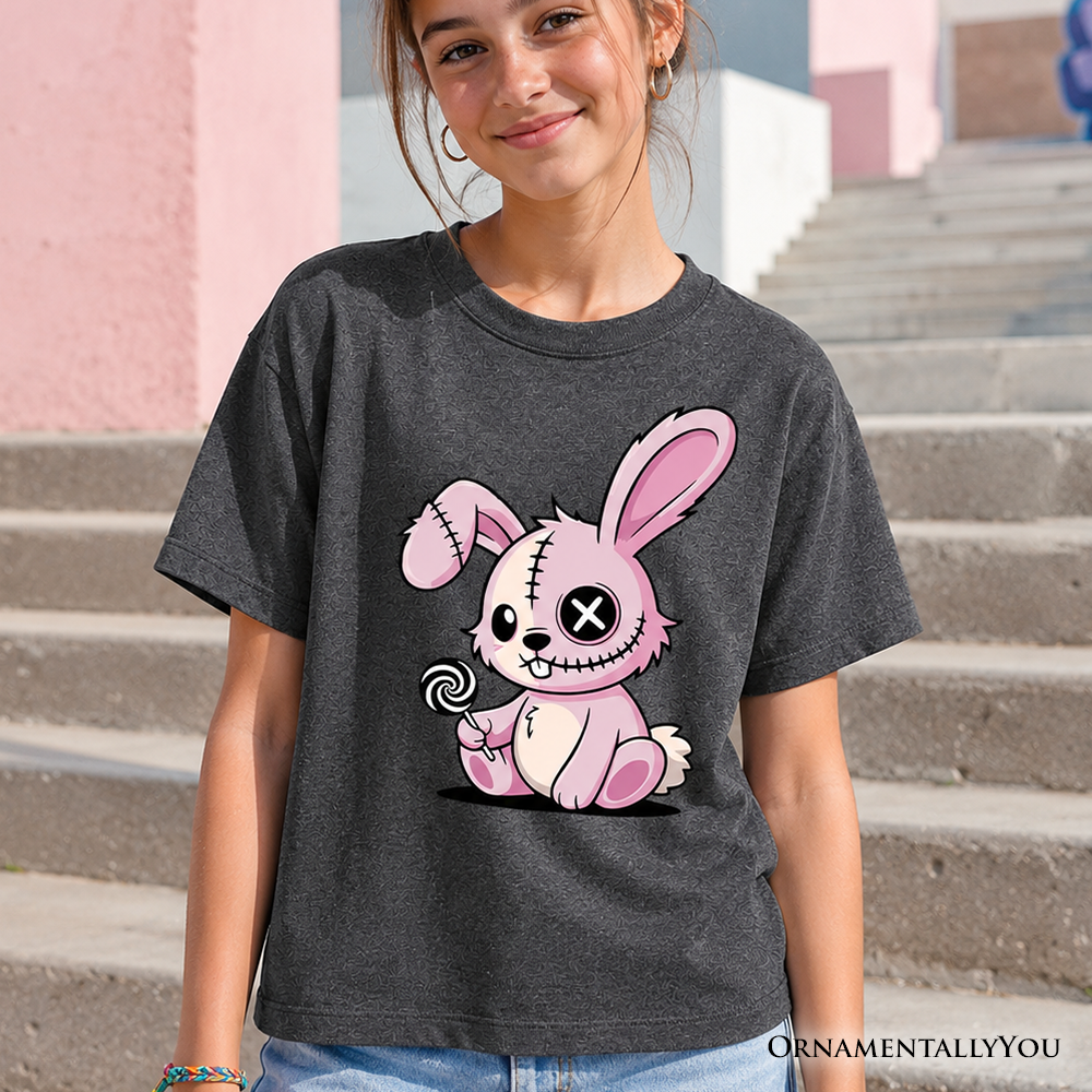 Child wearing a pink graphic t-shirt featuring a cute zombies bunny design for Halloween