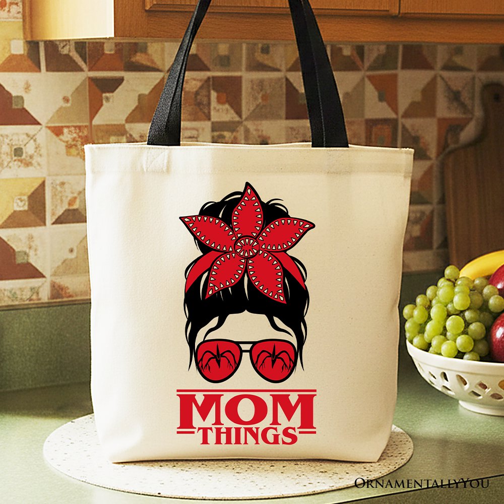 Mom Things retro canvas tote bag with messy bun, red bandana, and glasses graphic.