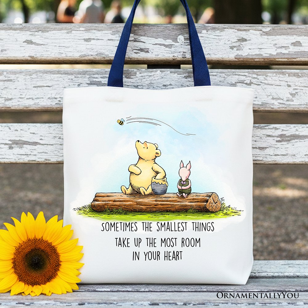 White cotton tote bag featuring Winnie the Pooh quote text in blue font