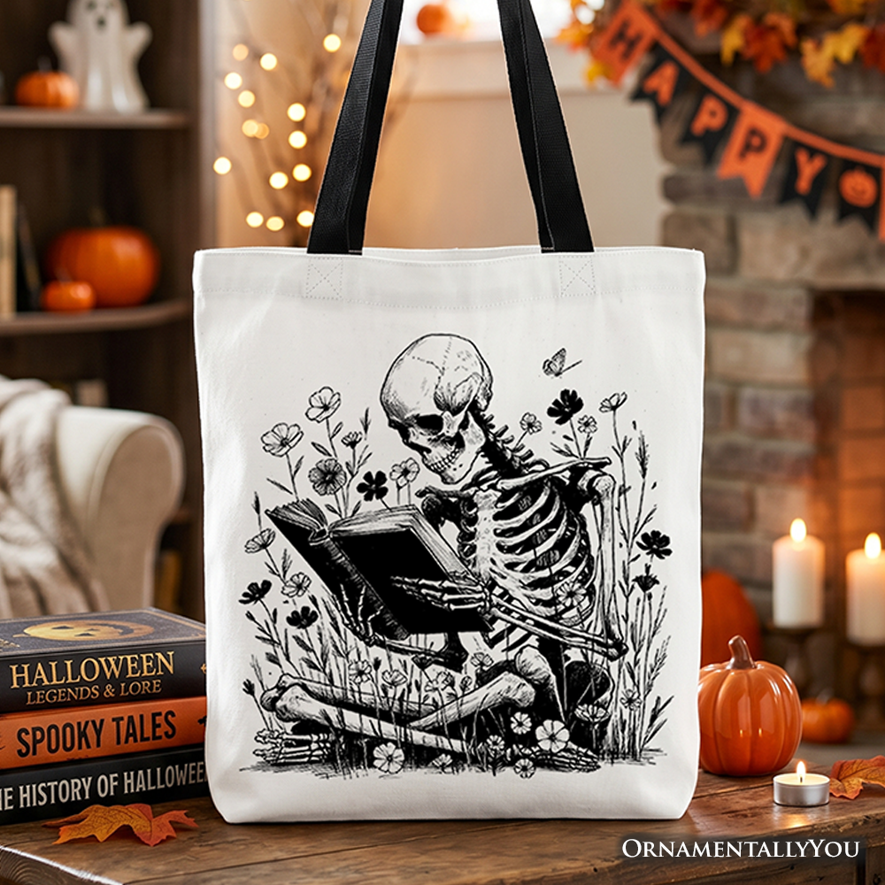 Natural cotton tote bag featuring a gothic skeleton reading a book with floral accents, shown in a lifestyle setting.