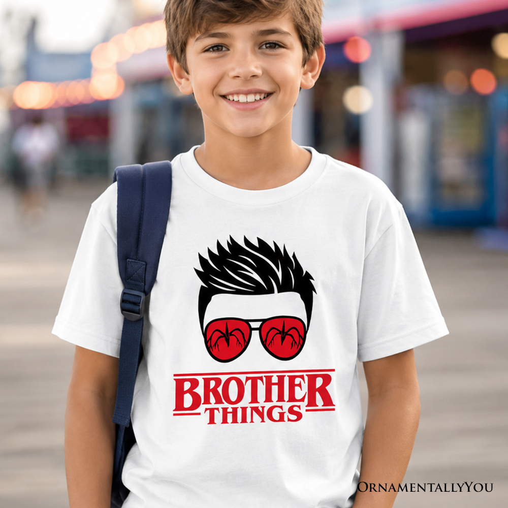 Kids wearing a retro Brother Things graphic t-shirt with red glasses, perfect for sibling matching outfits.