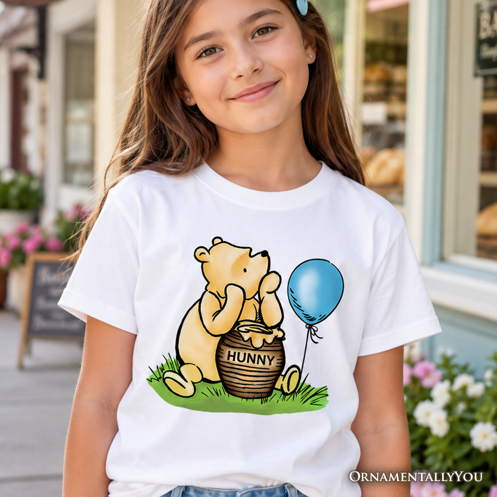 Charming Winnie-the-Pooh graphic youth t-shirt in yellow and white cotton fabric.