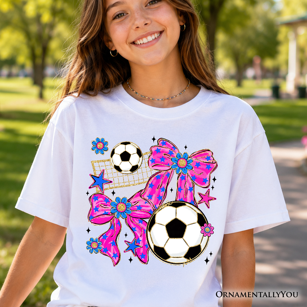 Girl wearing a pink soccer coquette graphic t-shirt with a bow print