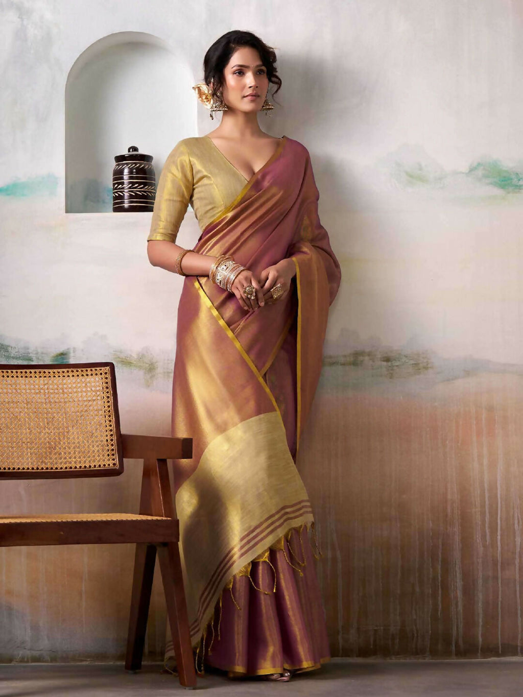 Purple tissue silk saree paired with a cream blouse for elegant festive styling