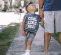 Kids crew neck t-shirt featuring a camo pattern in blue, grey, and white.