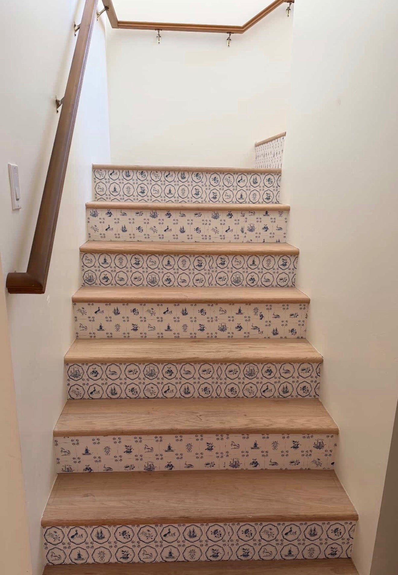 Traditional cream and blue patterned wallpaper in a coastal farmhouse style room
