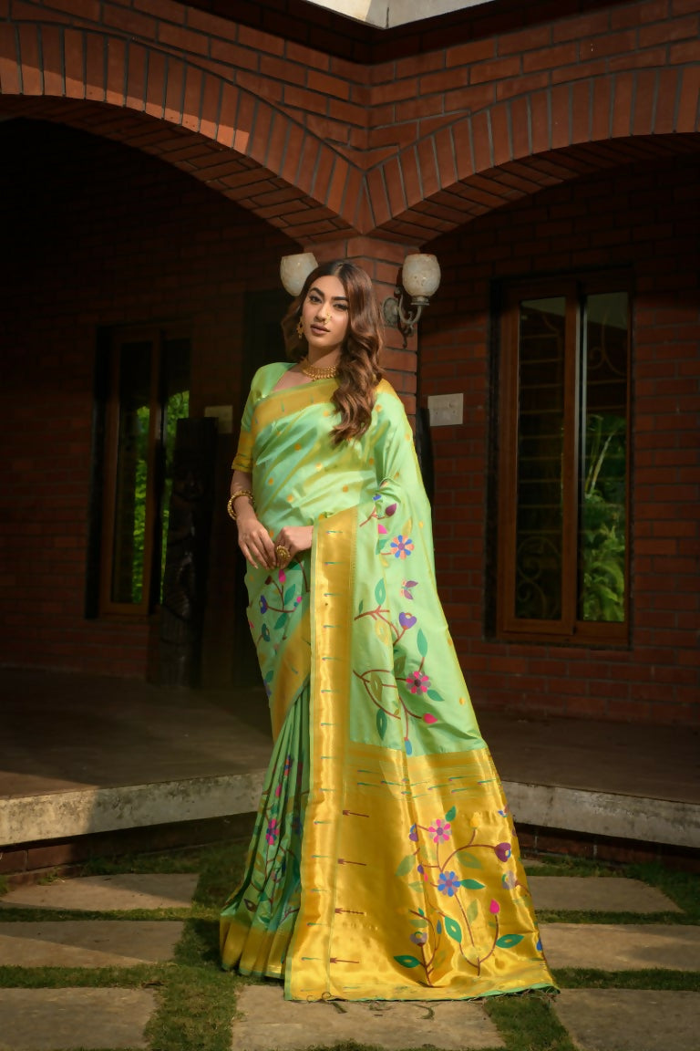 Sea green Paithani silk saree featuring detailed zari woven work and matching blouse.