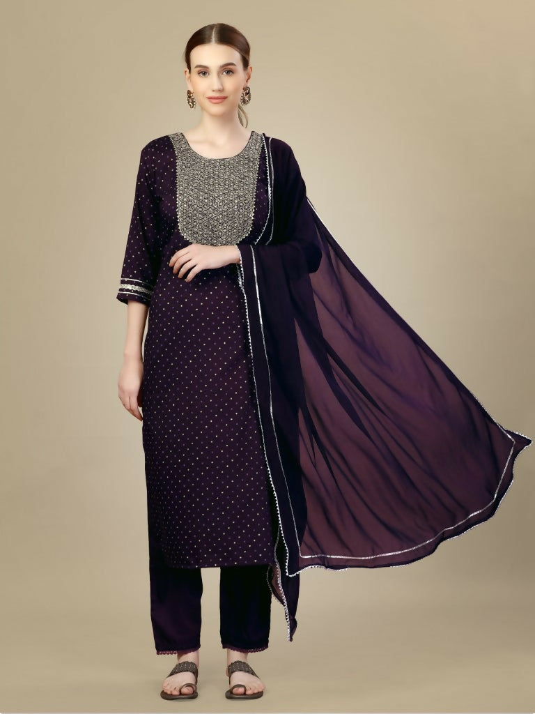 A woman wearing a purple silk blend straight kurta with intricate embroidery and sequence work, styled with matching trousers and a dupatta.