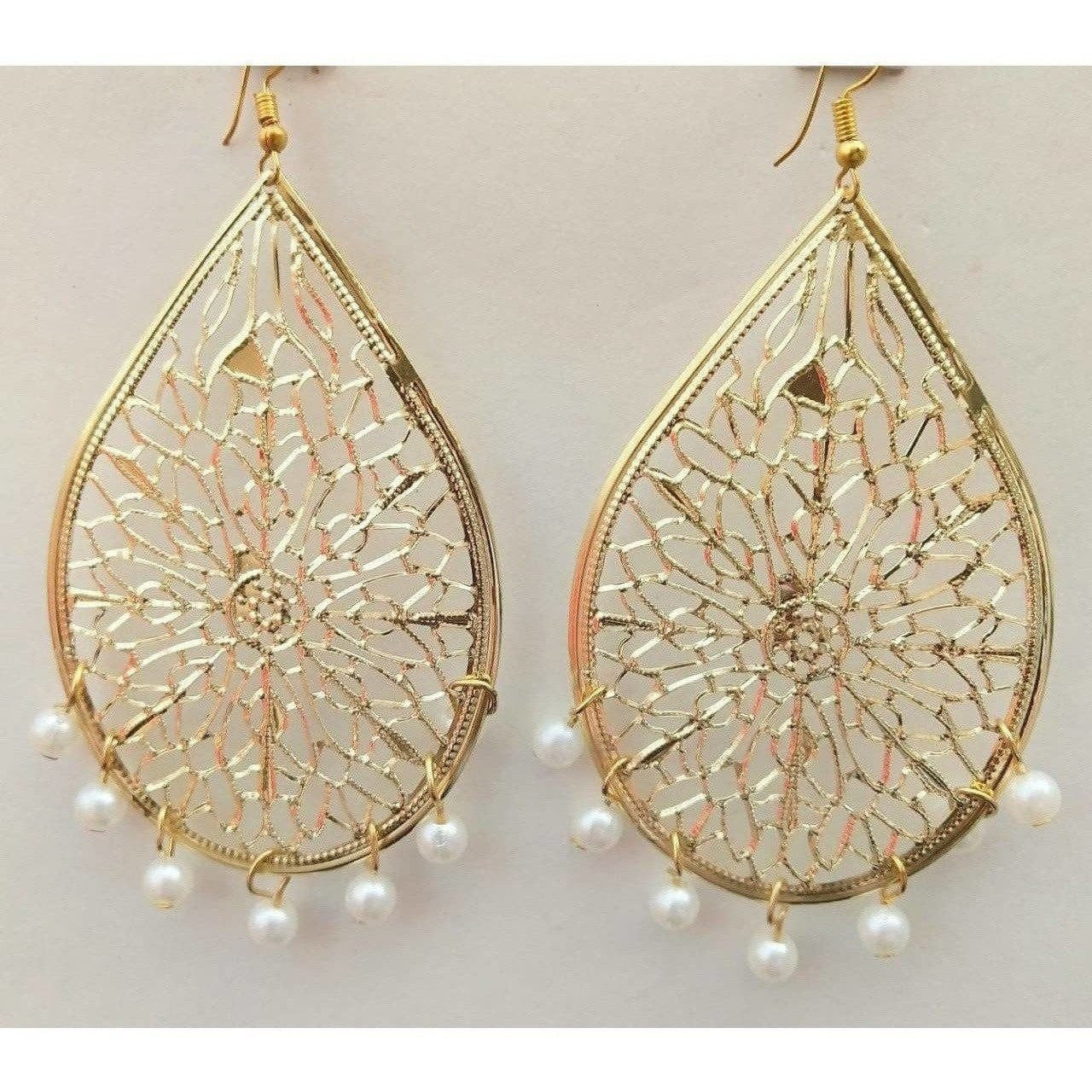 Gold-polished drop earrings featuring white pearl tassels for a formal party look.