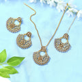Statement long necklace in gold-polished brass with golden and grey design elements.