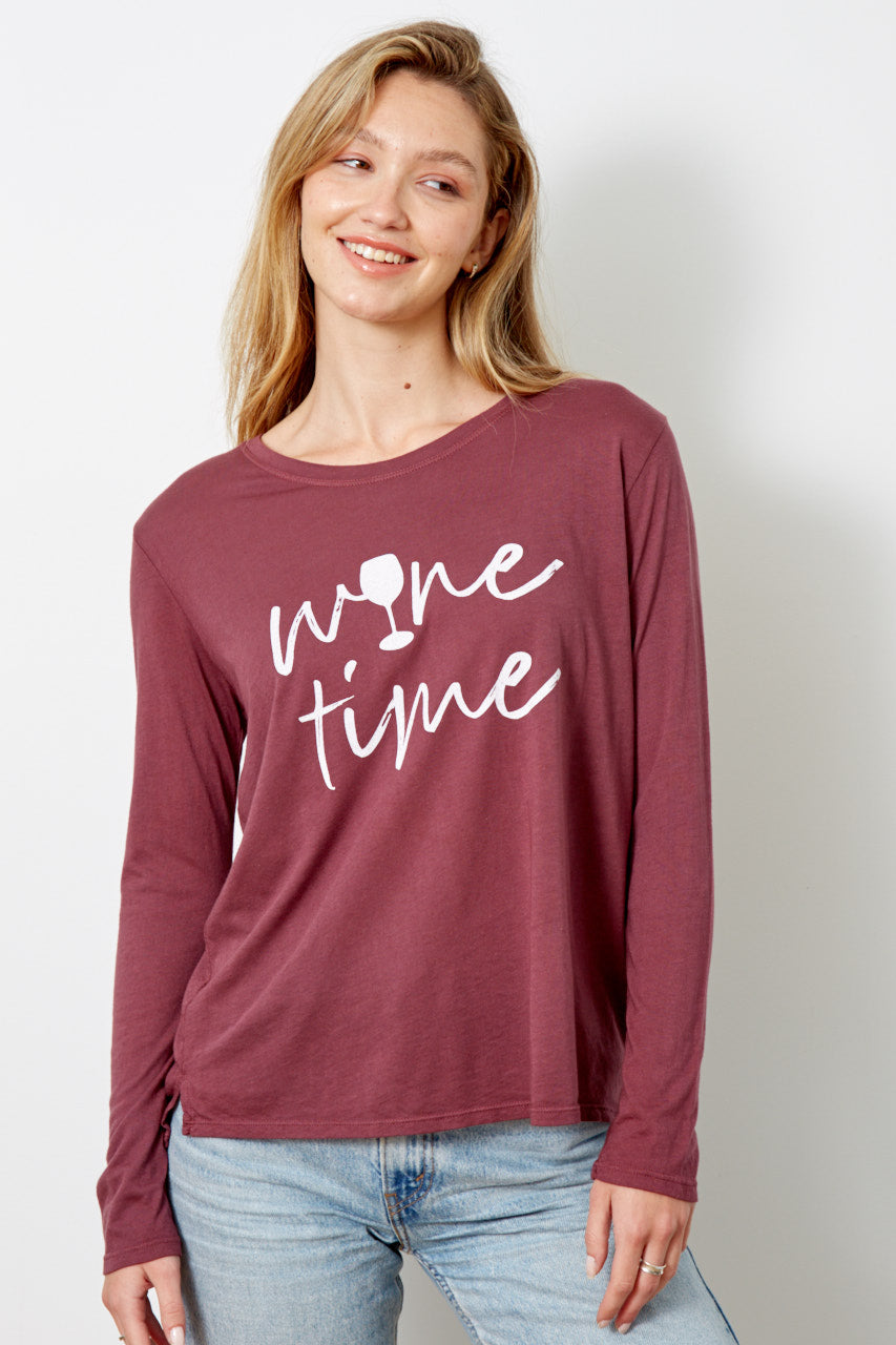 Model wearing a deep burgundy long sleeve t-shirt with Wine Time text in white