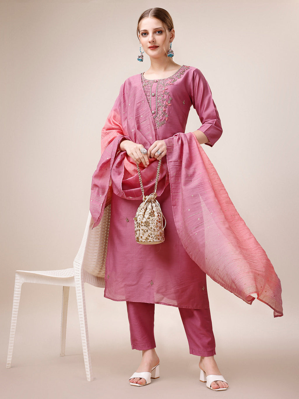 Woman wearing a multicolor hand-embroidered rayon kurta set with matching pants and dupatta