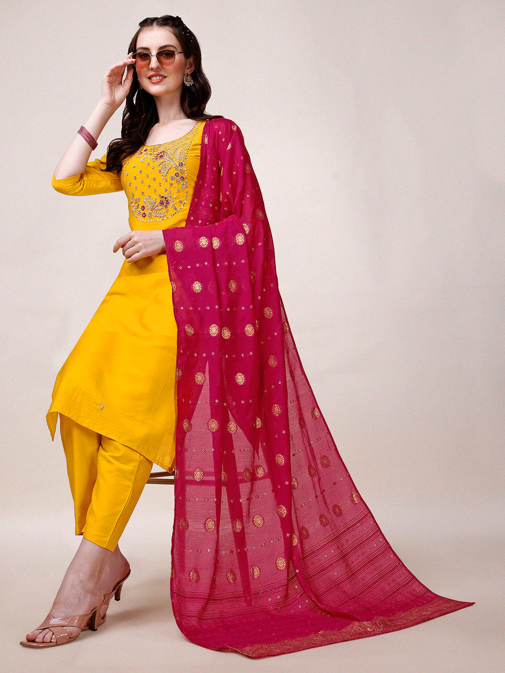 Woman wearing a yellow hand-embroidered rayon kurta set with matching pants and a dupatta