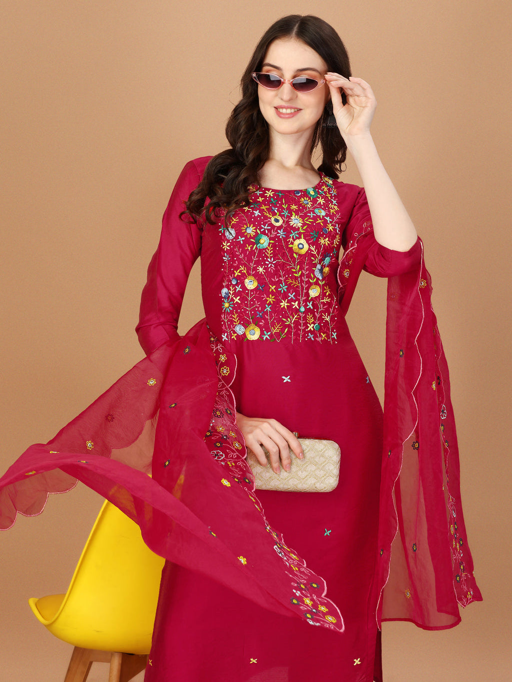 Model wearing a vibrant multicolor embroidered kurta set with matching pants and dupatta