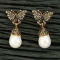 Pair of golden and white AD brass earrings featuring elegant design details.