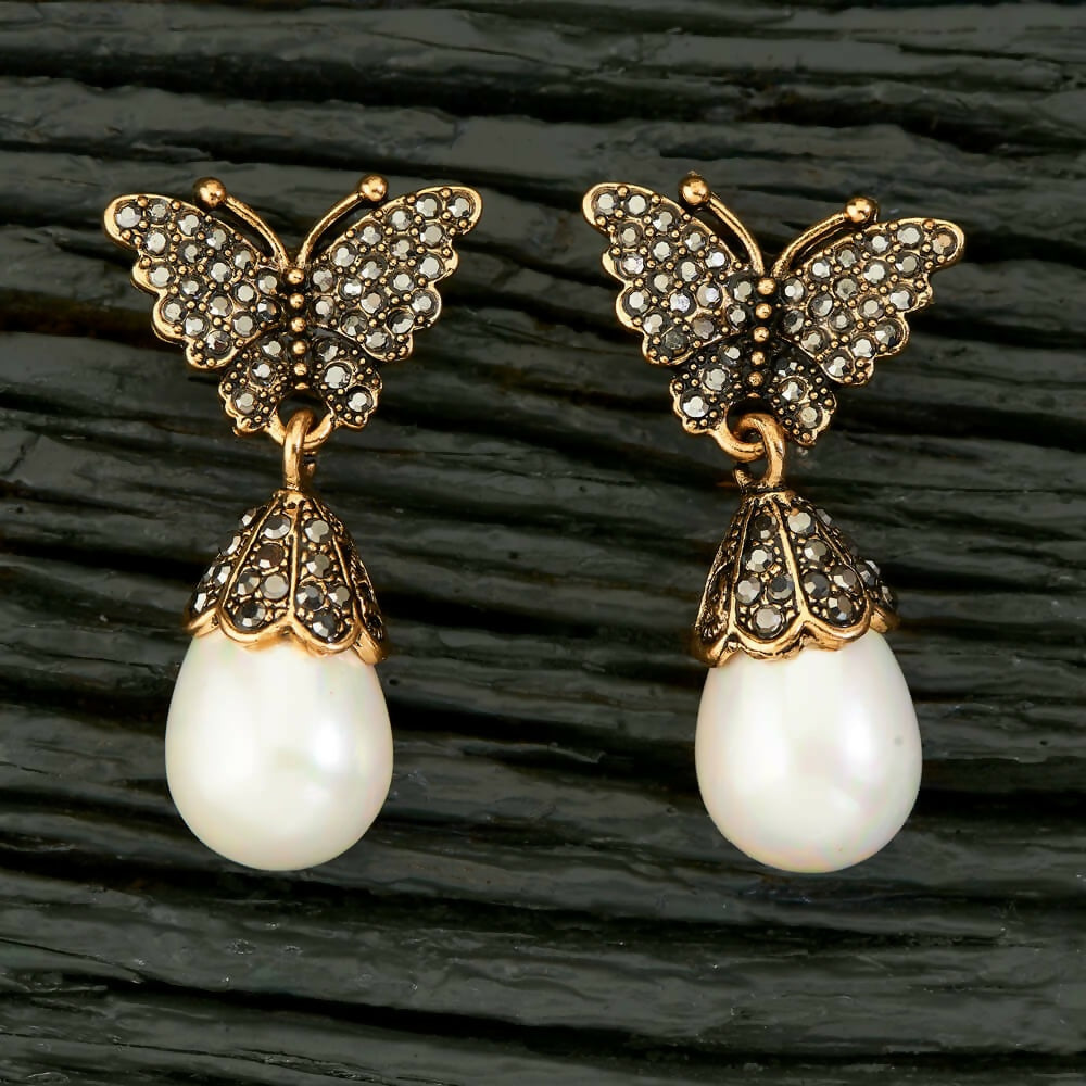 Pair of golden and white AD brass earrings featuring elegant design details.