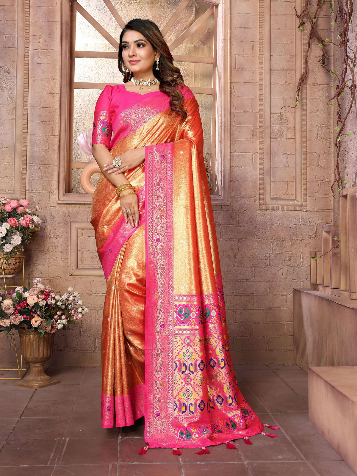 A luxurious gold Banarasi tissue silk saree showcasing fine metallic weaving and rich texture.