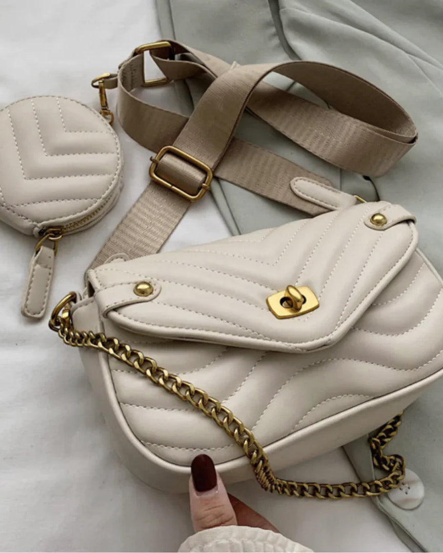 White quilted handbag with gold chain and matching coin purse on a light background