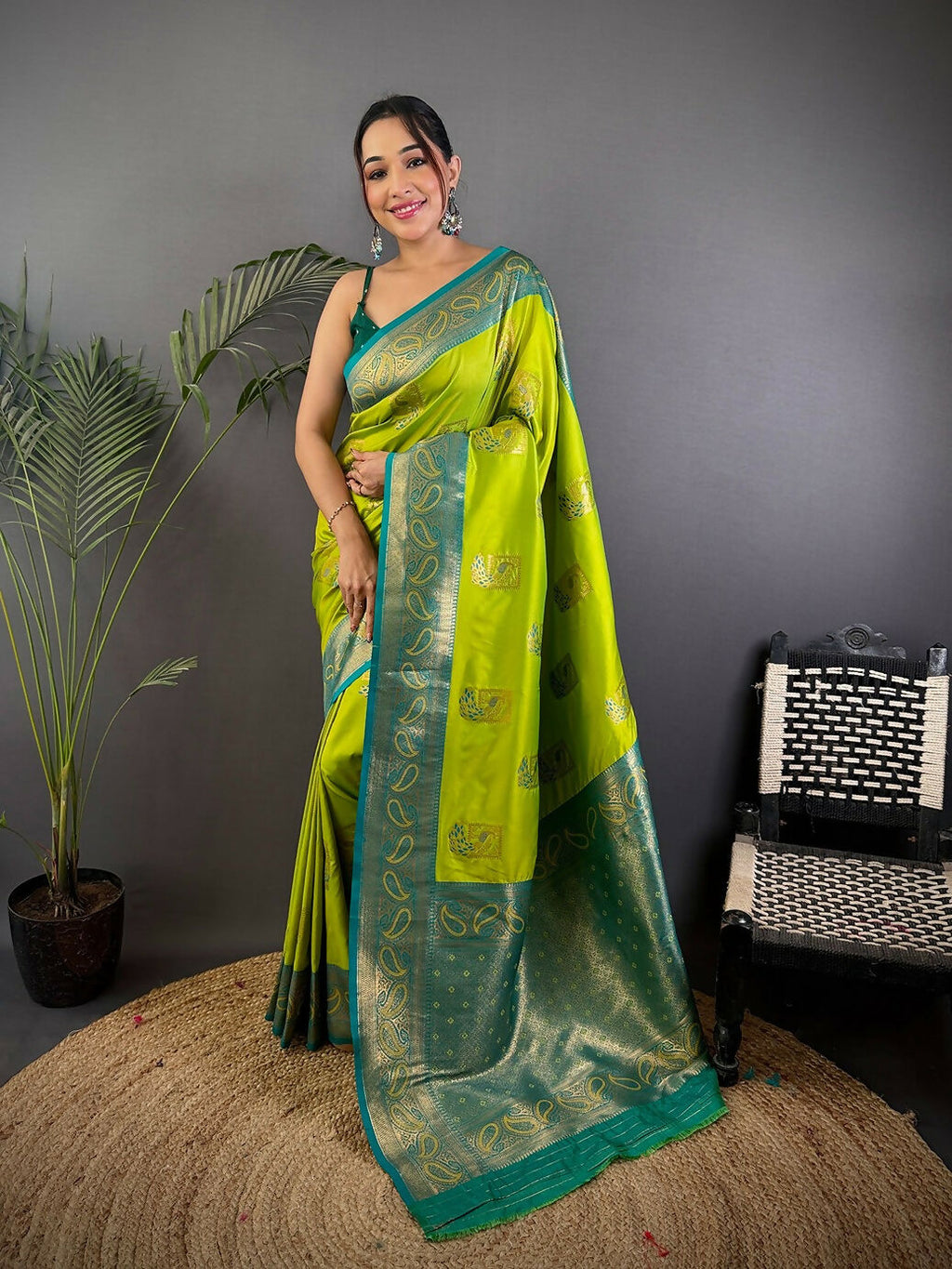 Stunning teal Banarasi silk saree featuring peacock motifs and unstitched blouse fabric.