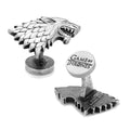 A pair of antique silver colored Game of Thrones House Stark direwolf head cufflinks on a plain white background.