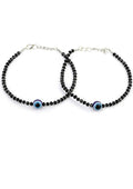 A pair of traditional silver-plated anklets featuring elegant black beads for ethnic and party wear.