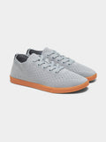 Women's minimalist grey knit sneakers with gum sole in a lifestyle setting