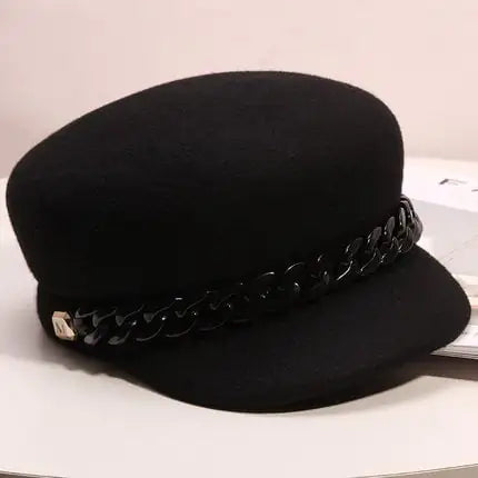 Women's wool newsboy caps in black and grey with decorative chain detail