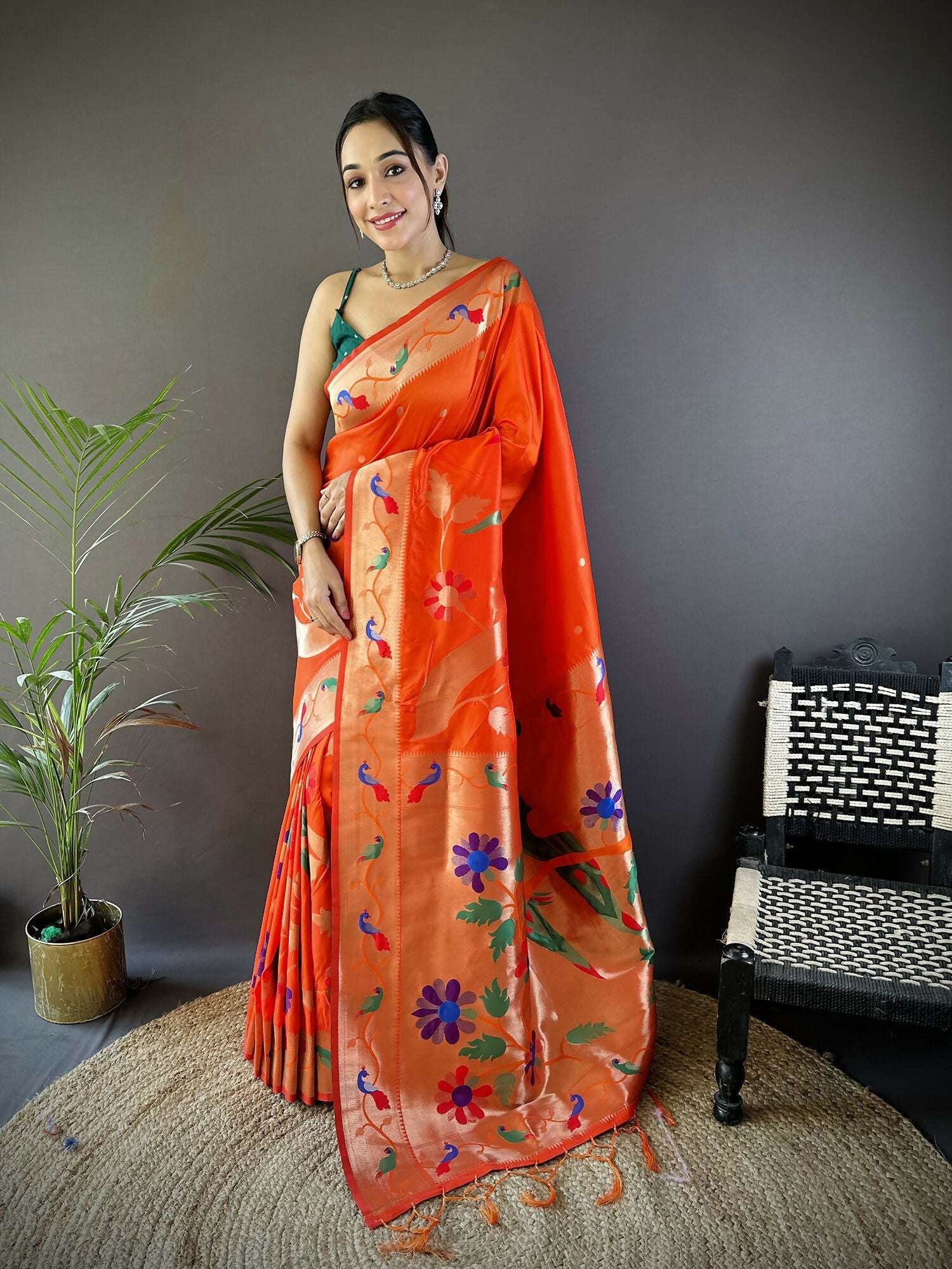 Beautiful orange soft silk Paithani saree with intricate zari floral motifs and a matching blouse piece.