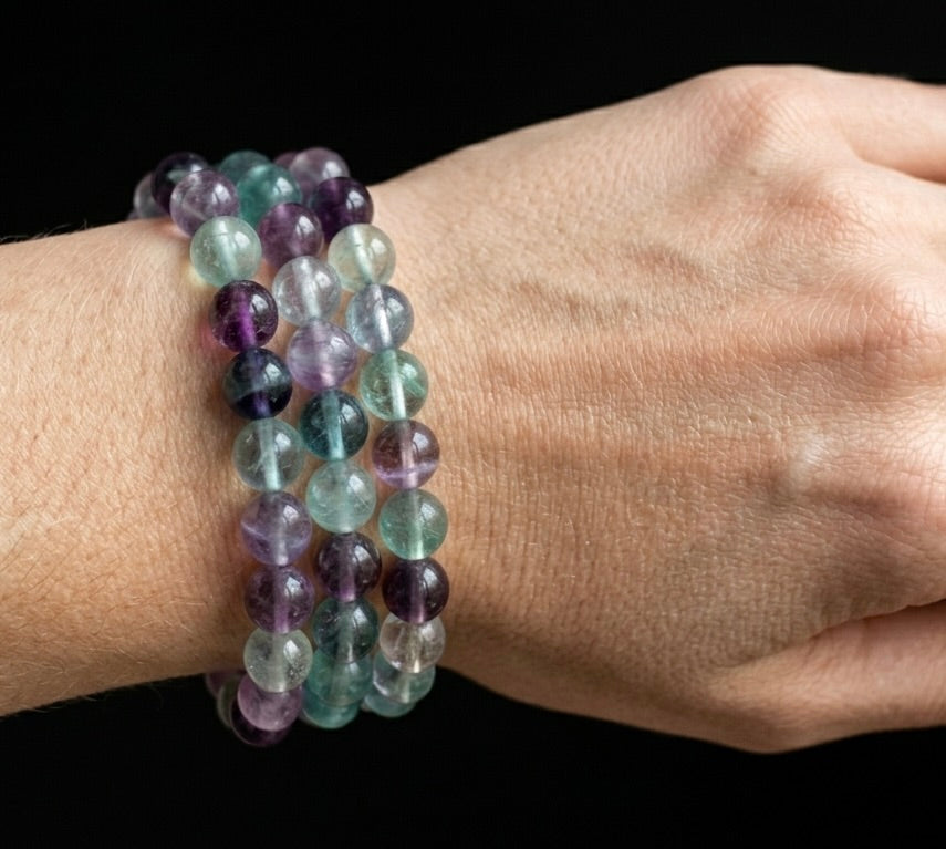 Soul Tide Fluorite bracelet featuring round, multi-tonal purple, green, and clear beads in a bohemian style.