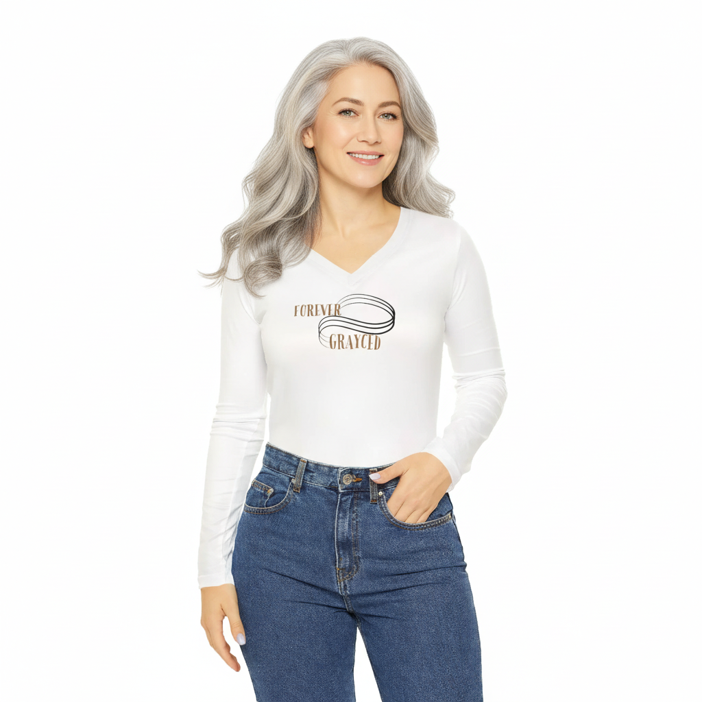 Woman wearing a fitted long sleeve white cotton V-neck shirt with inspirational black and bronze graphic text.