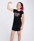 A young girl with pink-streaked hair wearing a black short-sleeved t-shirt with Equal Play graphic text.