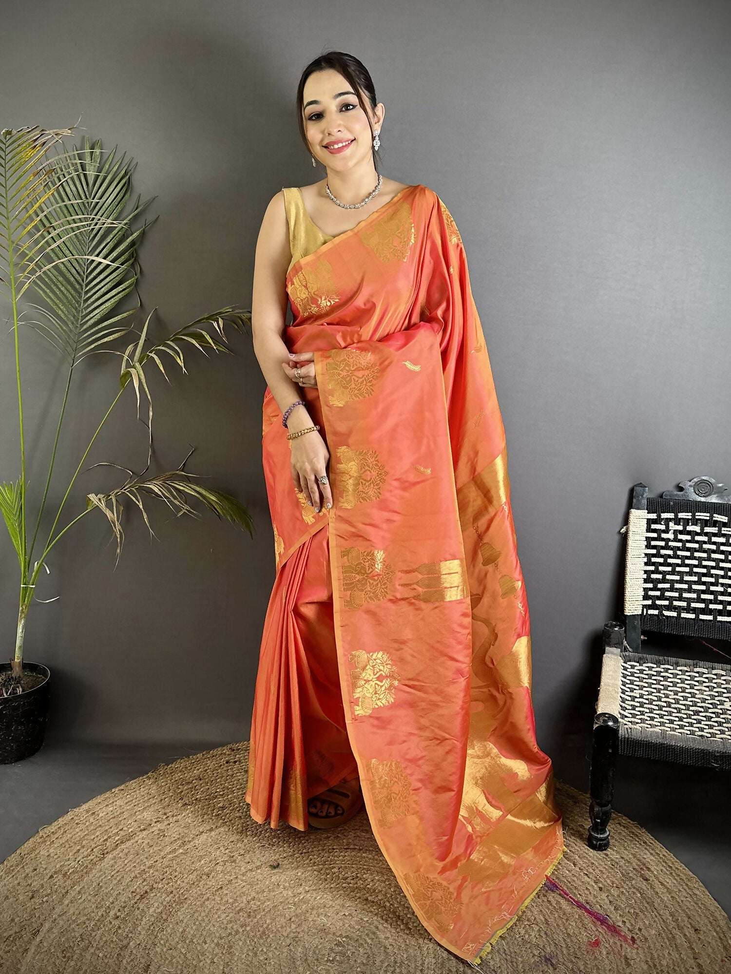 Orange Soft Silk Banarasi Saree with detailed gold Zari motifs and matching blouse piece