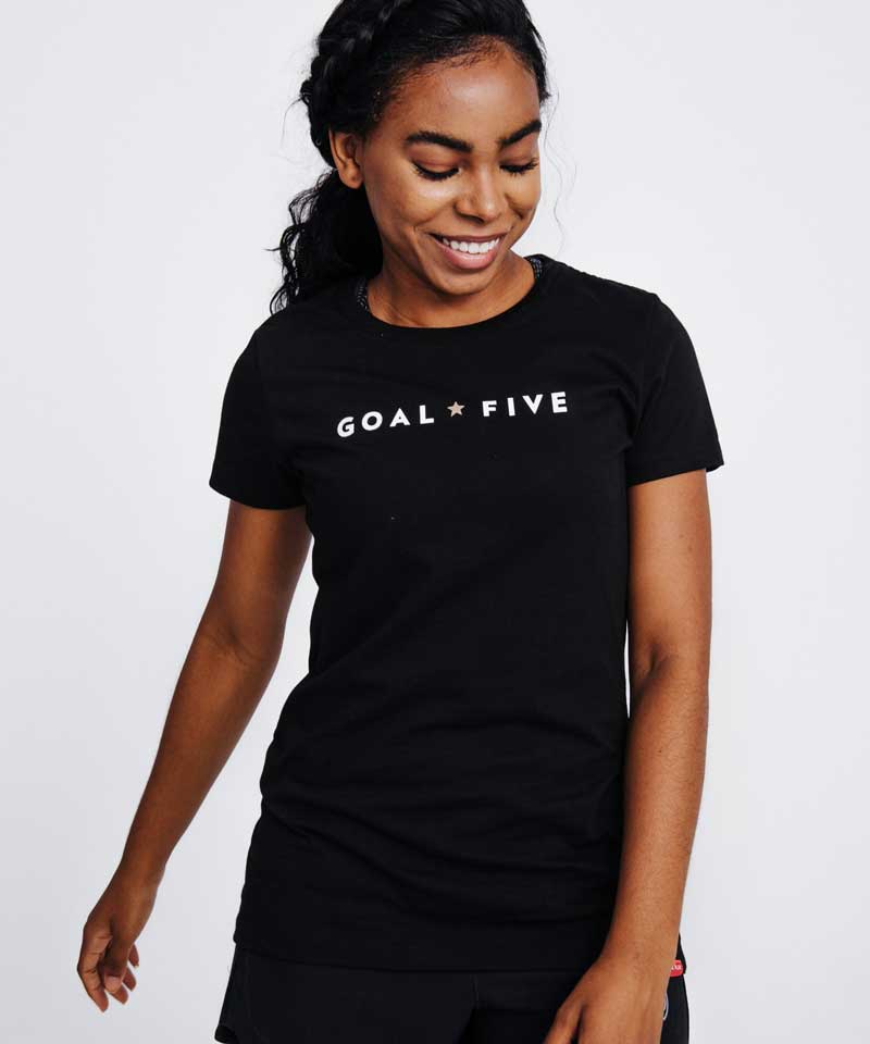 Model wearing a black crew neck athletic t-shirt with GOAL FIVE logo on the chest