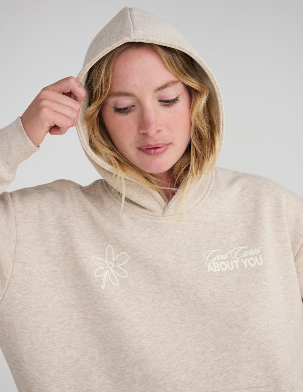 Minimalist beige unisex hoodie with God Cares About You design
