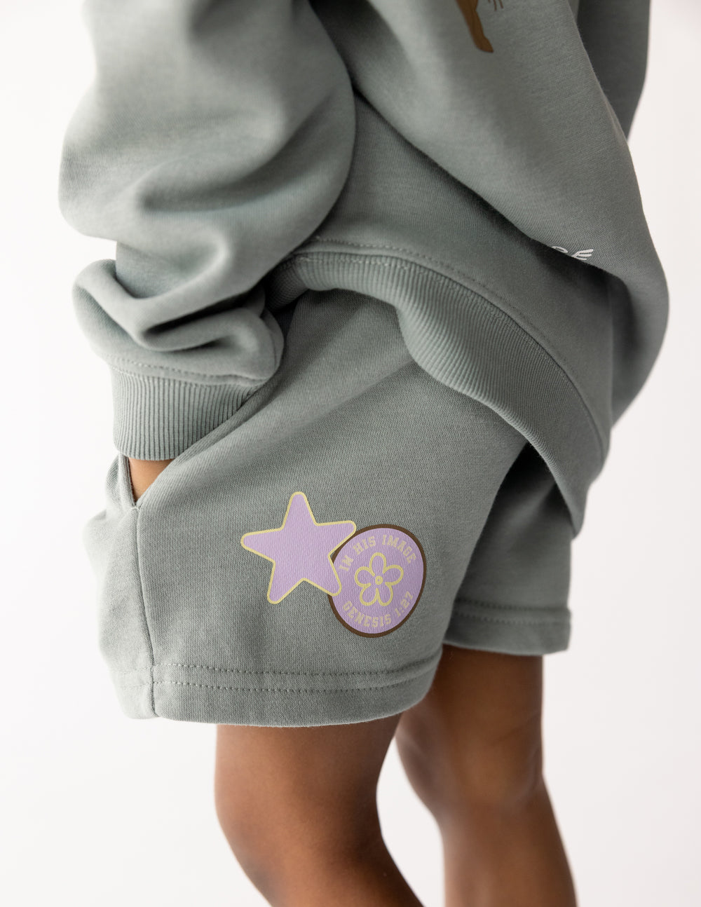 Kids sage green and lavender french terry shorts with graphic detail, relaxed fit, pull-on style.